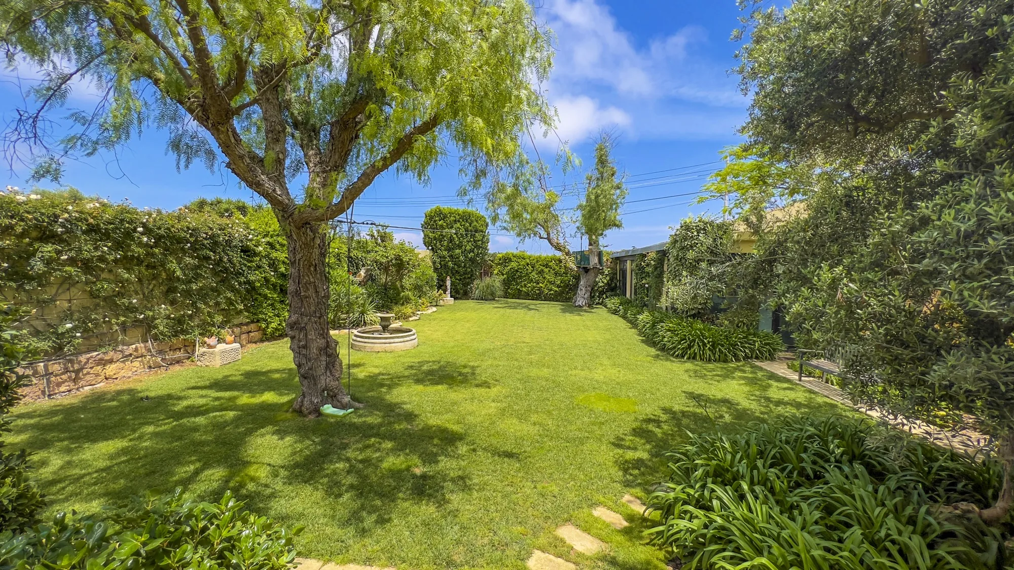 Outdoor dining table set for a wedding on the lawn at Nine Angels Villa