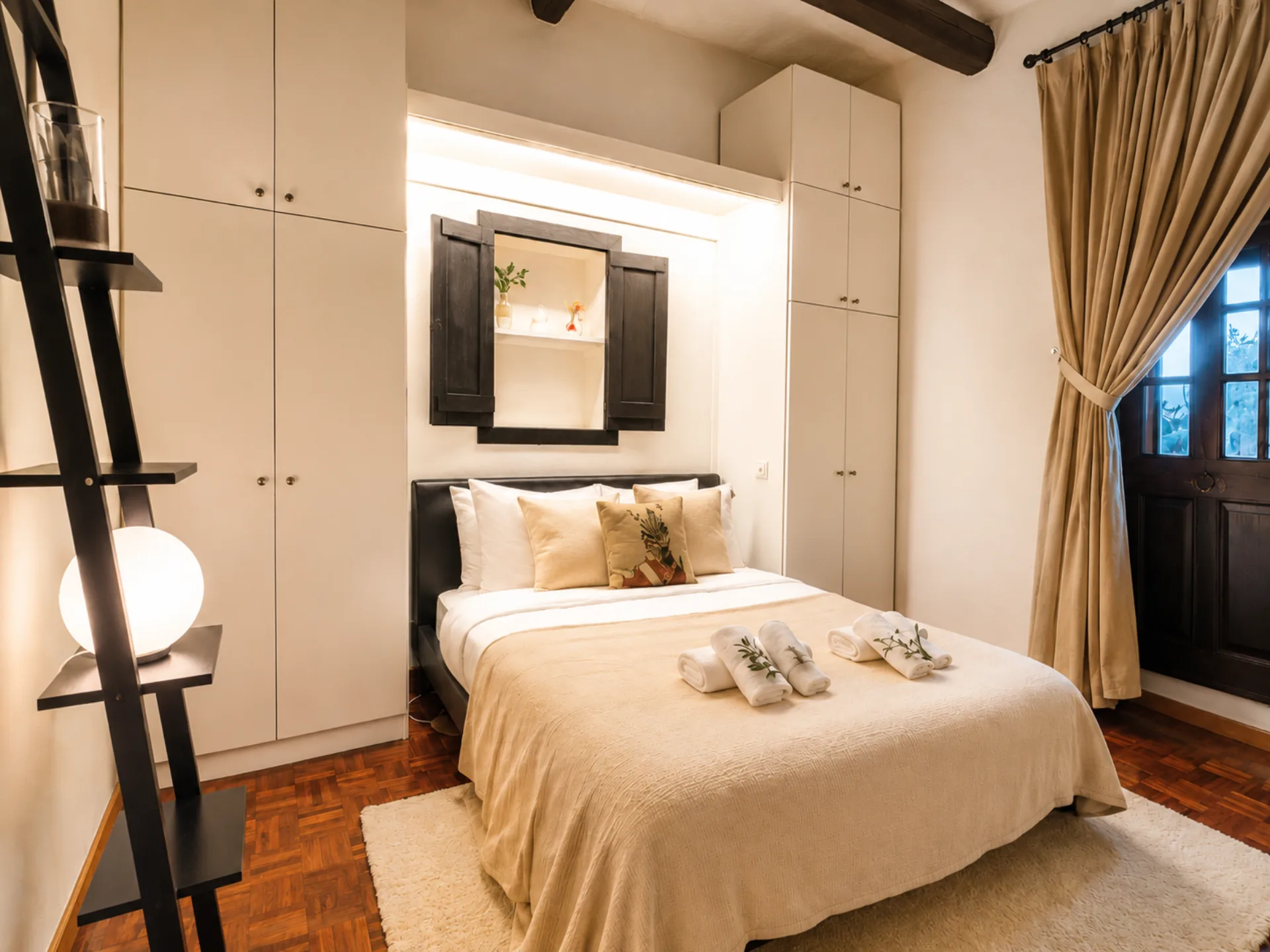 Guest queen bedroom with balcony and pool access at Nine Angels Villa