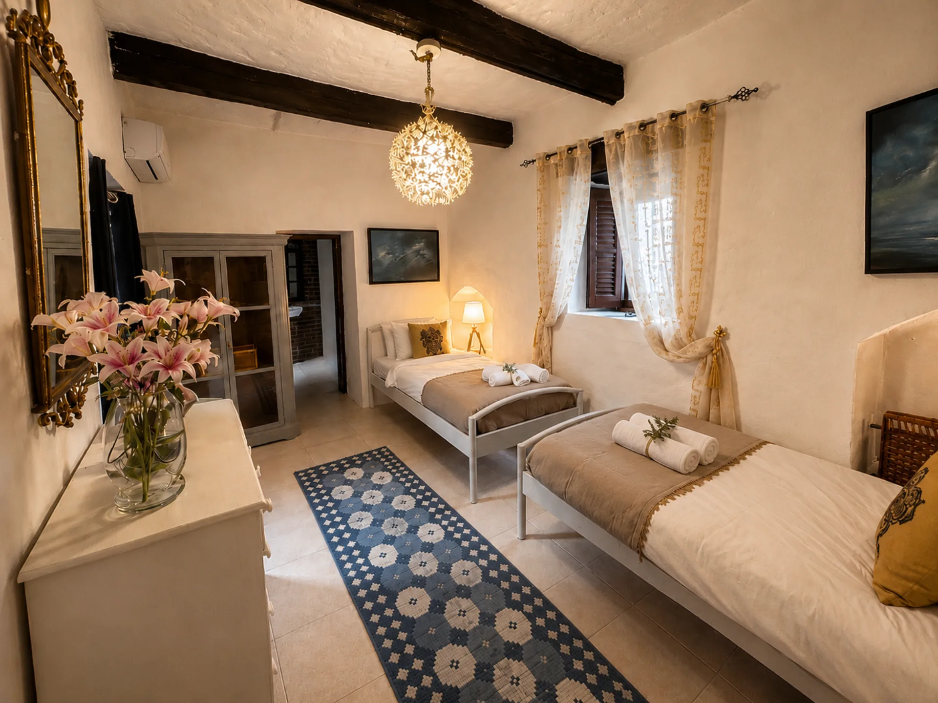 Guest twin ensuite bedroom with chandelier at Nine Angels Villa